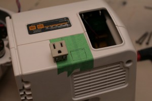 Find a location where your power socket will fit nicely, and mark it with tape.